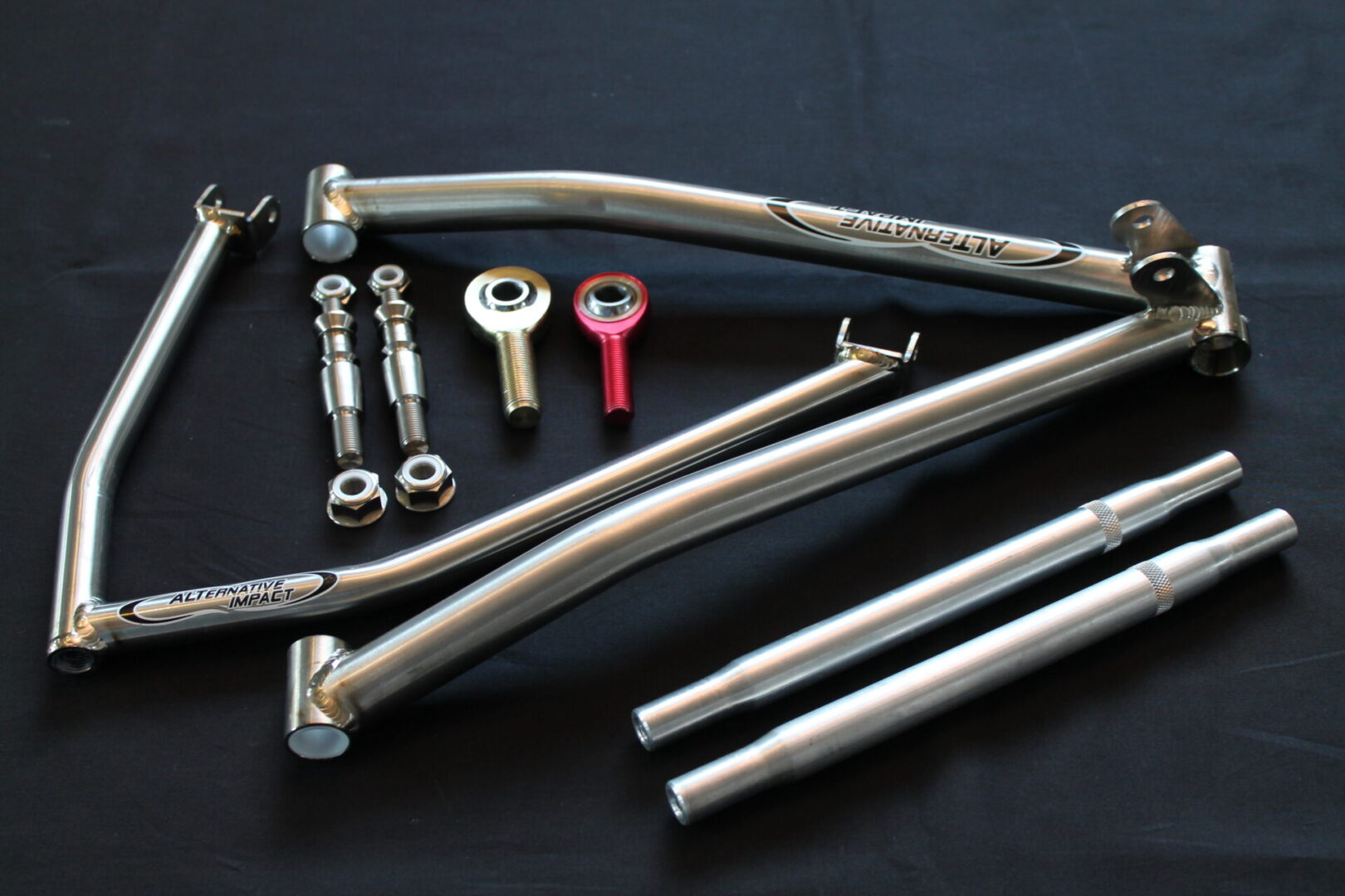 A set of 2012-15 Yamaha Viper 35.125” to 36.5” Titanium A-Arm Kit parts and tools on a black surface.