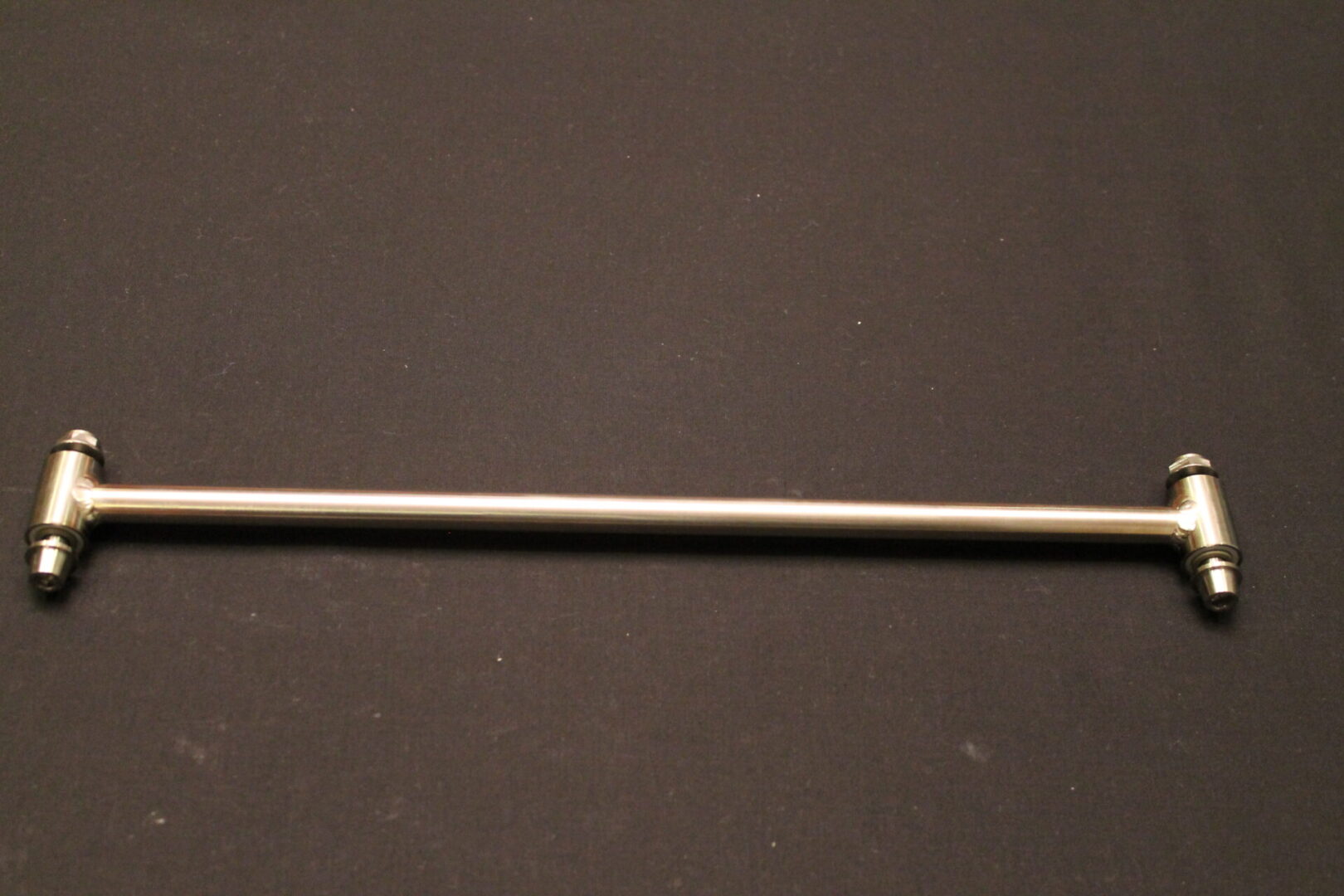 An 11-15 Pro Titanium Shock Rod w/ HCT Coated Alum. Bushings on a black surface.