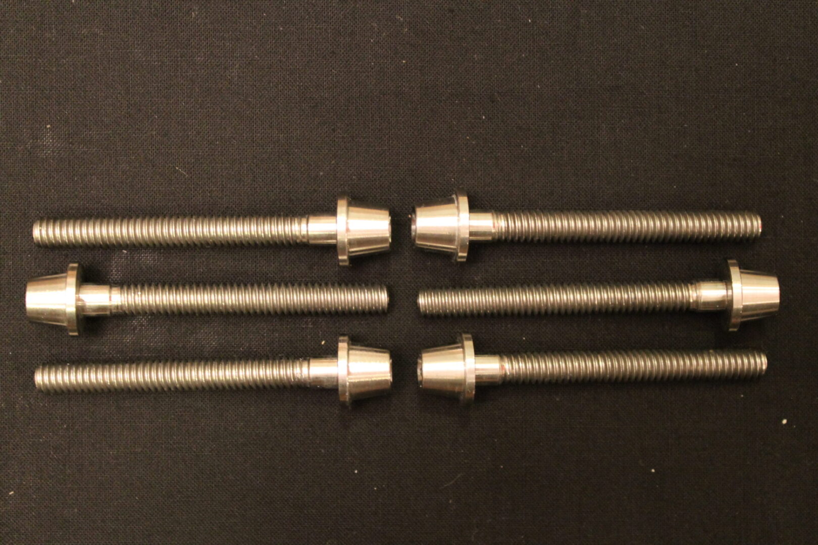 Six Bolts on a Dark Color Background