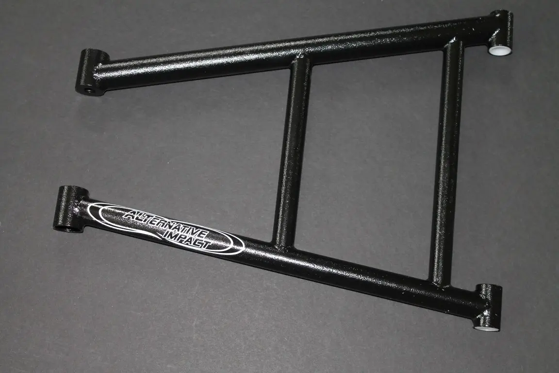 A pair of M-Chassis 36.5” Cro-moly/Docol Lower A-Arm bike frames on a gray surface.