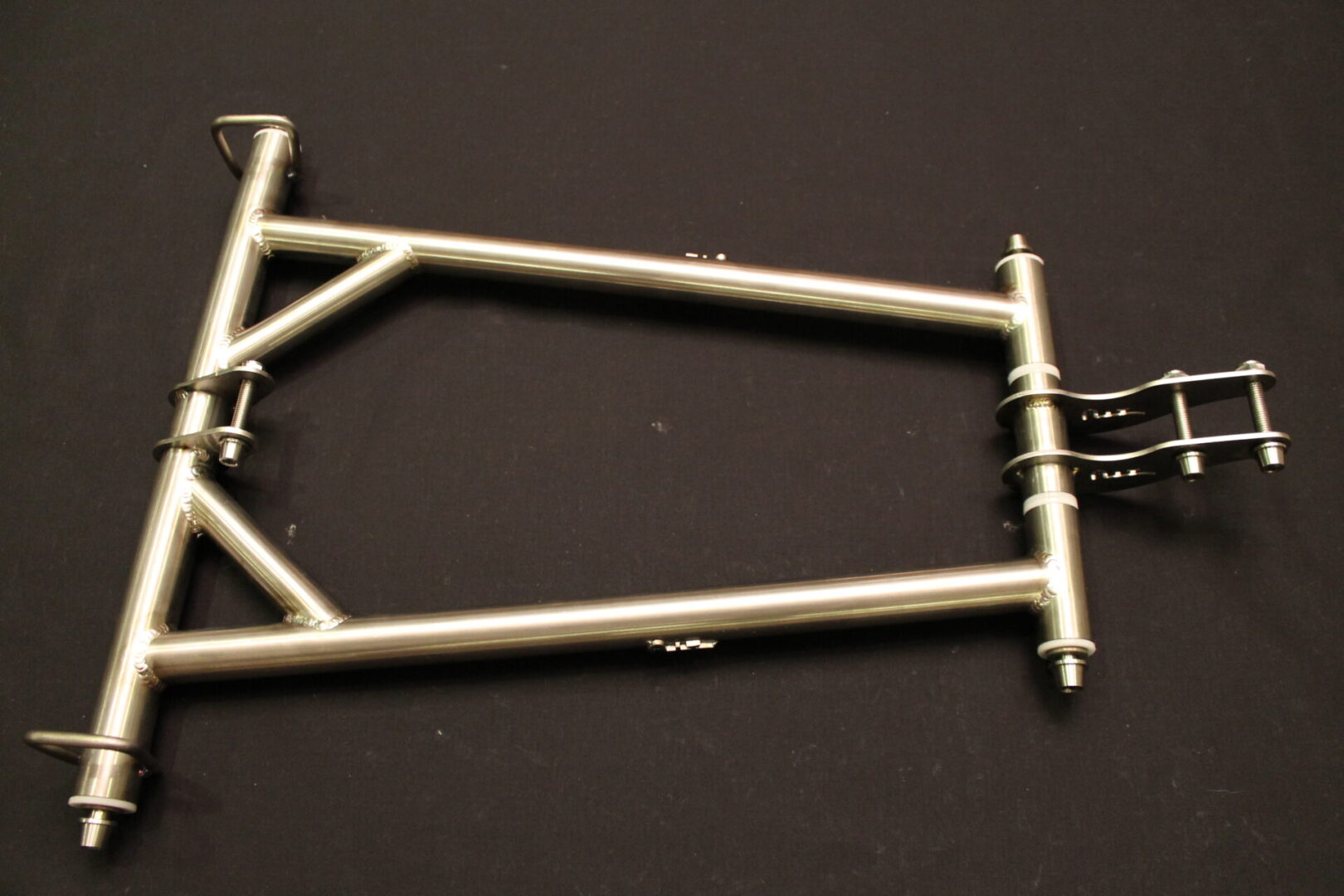 An image of a 11-23 Pro/Axys Titanium Rear Suspension Front Torque Arm on a black surface.