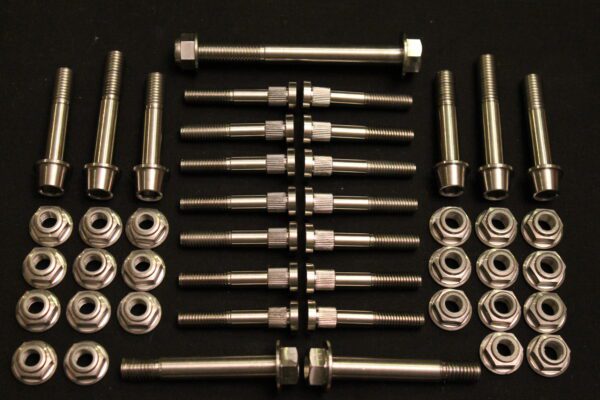 A set of 2011-2024 Polaris Pro Titanium bolts and nuts on a black surface.