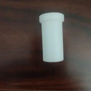 A white plastic container on a wooden table.