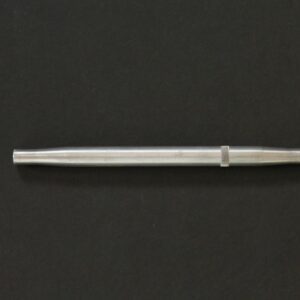 A silver pen on a black surface.