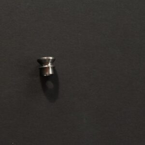 A small piece of metal on a black surface.