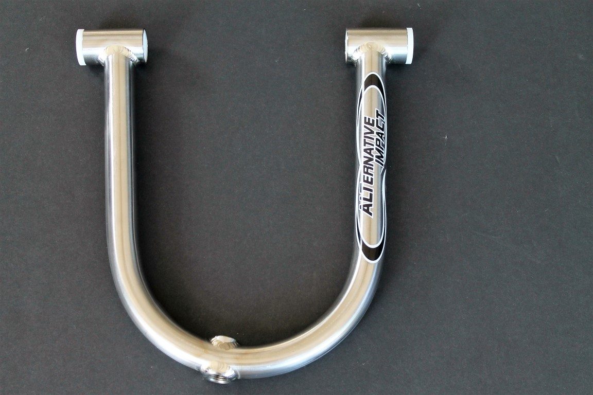 A silver u shaped handlebar on a black surface.