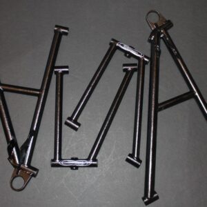 A group of metal rods laying on a gray surface.